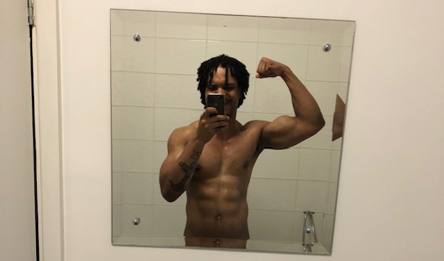 lean guy showing bicep and abs