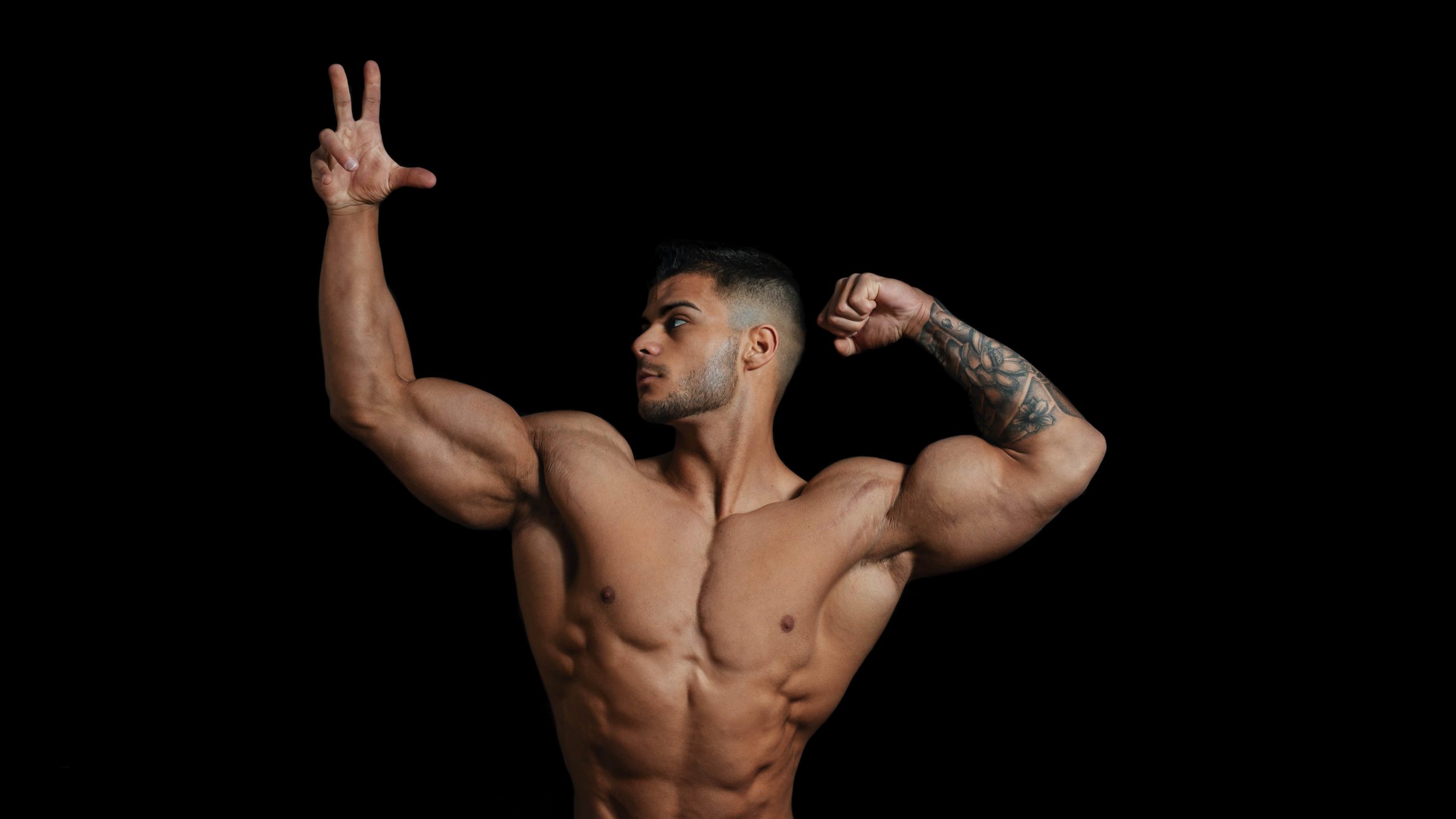 muscular man in dark room posing